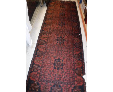 A Caucasian runner the central panel set with repeating star medallions on a red ground with all over floral decoration withi