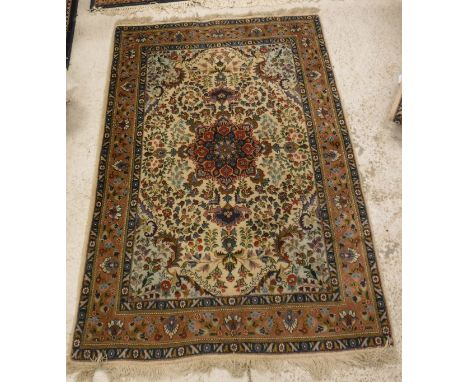 A pair of Persian rugs, the central panel set with foliate decorated medallion on a cream floral decorated ground within a st