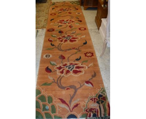 A modern Oriental style runner, the peach ground with multi coloured floral sprays, approx 95cm x 346cm  