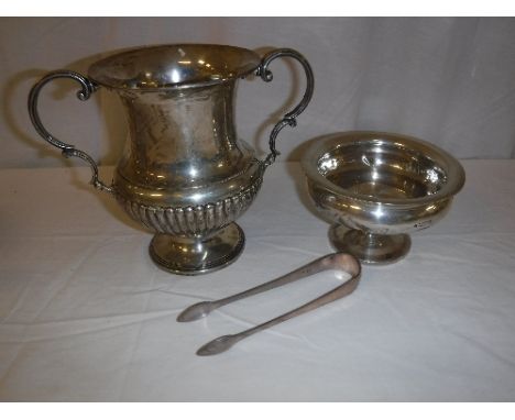 A collection of silver ware to include a twin-handled trophy cup, a small pedestal bowl, silver "Fiddle" pattern table fork a