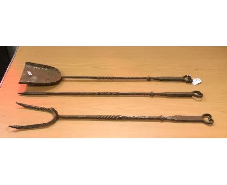 A set of three steel fire tools in the Arts and Crafts manner comprising shovel, poker and fork, together with a further set 