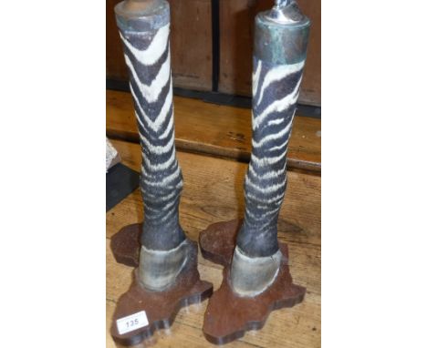 A pair of Zebra leg ashtray and cigarette lighter on carved wooden bases as "Africa" (ashtray top missing)  Size approx 39am 