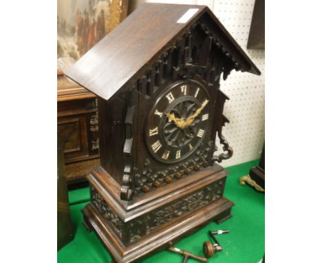 A late 19th Century carved oak cased mantel cuckoo clock, the eight day twin fusee movement with six air Swiss musical box, b