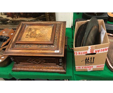 A Victorian walnut cased table top polyphone, the top with marquetry inlaid panel and blind fretwork decorated frieze opening