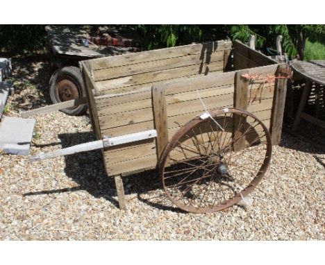A vintage wooden cart with iron wheels  Size approx. 113cm long x 67cm wide
