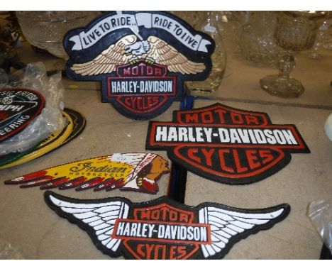 A collection of four reproduction "vintage" American motorcycle signs including "Indian Motorcycle", "Harley Davidson Live to