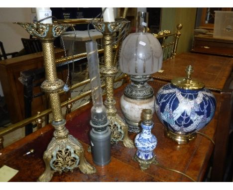 A pair of pierced brass Continental table lamps, a Chinese blue and white and gilt metal table lamp of small proportions, a D