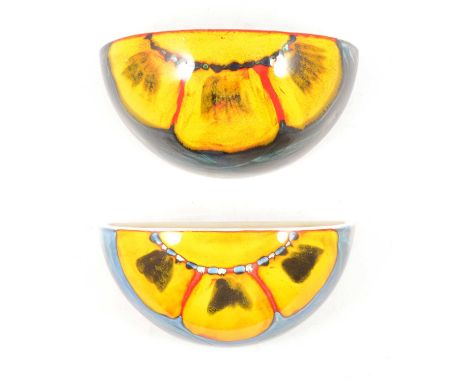 A pair of Poole Pottery Wild Poppy pattern wall light sconces, 29.5cm diameter.Qty: 2Condition report:Both are good with no c