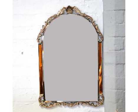 A decorative wall mirror, arched plate with rectangular peach panels to the sides, gilt and silvered scrolled mounts, width 4