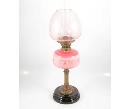 Victorian oil lamp, moulded glass shade and chimney, pottery reservoir, brass column on a circular plinth, 66cm.