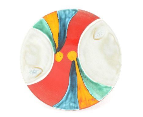 A large Poole Pottery circular charger, in tones of red, yellow, green, blue and grey, 41cm diameter.