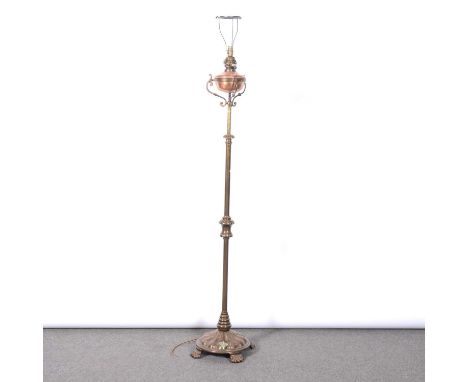 Victorian brass standard lamp, plain column, circular embossed base on four paw feet, converted to electricity, 161cm.