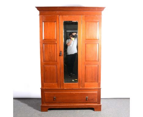 Edwardian walnut mirror door wardrobe, moulded cornice, the door enclosing hanging space, drawer under, bracket feet width 12