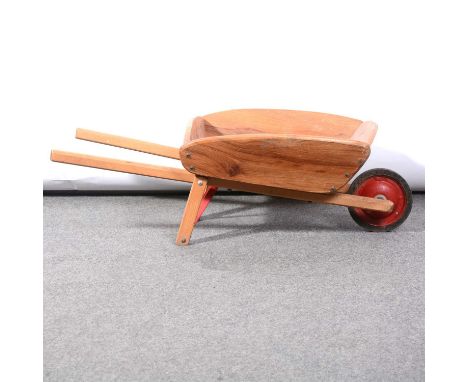 Vintage wooden child's wheelbarrow. by Good Wood, length 82cm; and an oval gilt framed cast metal mirror, ribbon surmount and