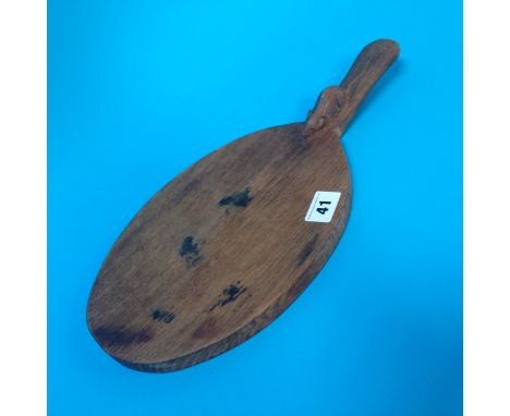 A Robert Mouseman Thompson of Kilburn oval cheese board, with carved mouse to the handle, 37cm length