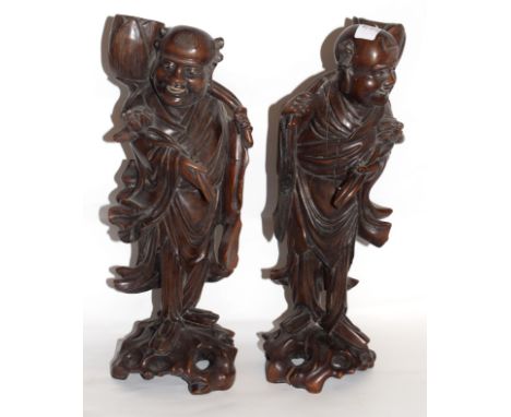 Pair of carved wooden Chinese figures on scroll bases (2)   
