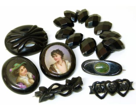 2 portrait miniature jet brooches, together with three other jet brooches and a jet bead bracelet.Condition reports are not a