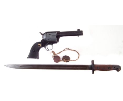 SMLE Wilkinson Bayonet dated 1907 , also a pair of dog tags named Rowlands, and a replica Colt SAA Peacemaker. The bayonet me