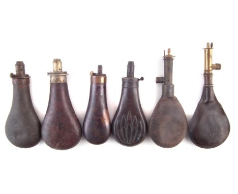 Four brass and copper powder flasks and two shot flasks , one marked Bartram and Co., one shotflask marked Baftie Patent, the