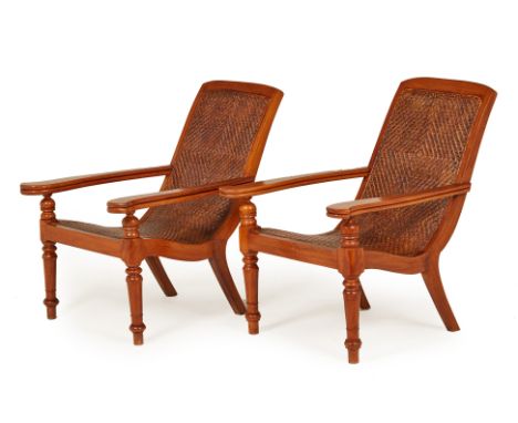 A PAIR OF TEAK PLANTER CHAIRS
Of typical form with caned seat and turned front supports
96cm high x 54cm wide
Condition: No o