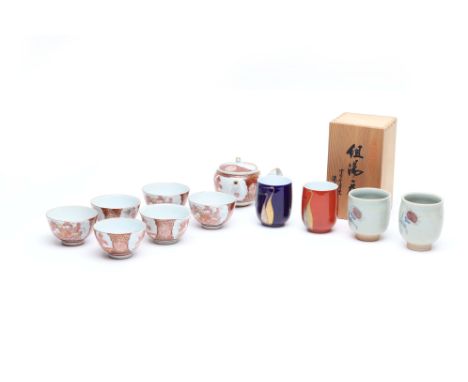 A JAPANESE TEA SERVICE AND CUPS
Consisting of six tea bowls, one with a lip, and teapot, marked to the bottom, and two pairs 