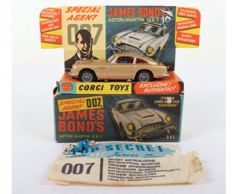 Corgi Toys 261 James Bond Aston Martin D.B.5 from the Film “Goldfinger” gold body, with working ejector seat, rear bullet scr