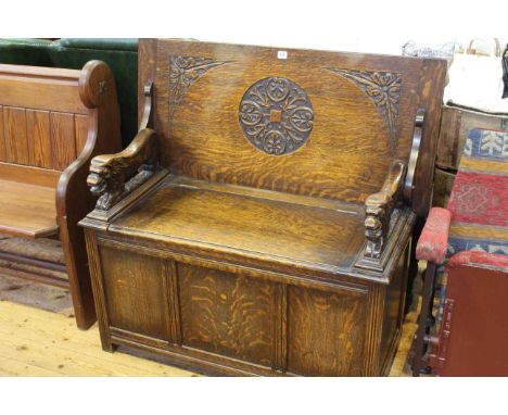 Carved oak monks bench with lion carved arms