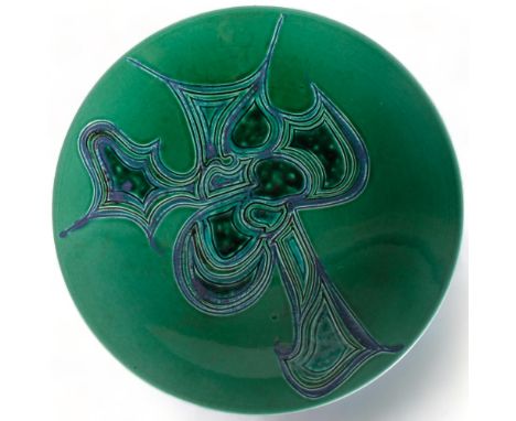 Poole Pottery, a large Delphis charger with carved and glazed abstract design on green ground, makers mark to base, diameter 