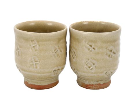 Jim Malone (b.1946), Ainstable Pottery,  a pair of ash glaze Yunomi / tea-bowls, makers marks to base, height 9cmGood conditi