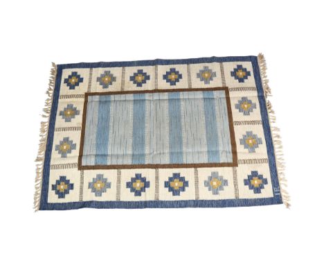 Ida Rydelius, Sweden, a double sided flat weave Rollakan rug, central blue shaded panel, with geometric flower borders, signe