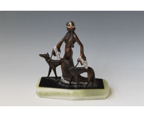 A COLD PAINTED BRONZE FIGURE OF A LADY WITH DOGS, with green onyx base and a label to base reading 'Baronite sculpture, Baldo