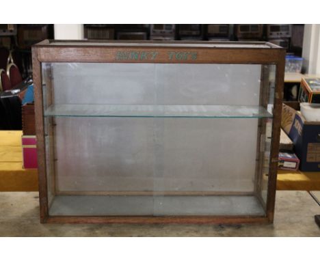 AN ORIGINAL DINKY TOYS GLAZED DISPLAY CABINET, two sliding doors to the front and one glass shelf, H 61 cm, W 81 cm Buyers - 