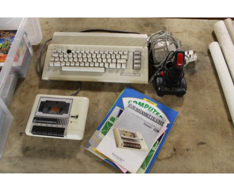 A COMMODORE 64 COMPUTER WITH TAPE RECORDER, together with a large selection of assorted games, joystick, manuals etc. A/F Buy