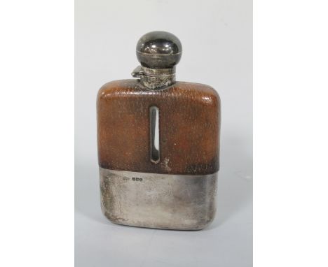 A SILVER MOUNTED AND LEATHER COVERED HIP FLASK, hallmarked Sheffield 1927, H 15 cm Buyers - for shipping pricing on this lot,