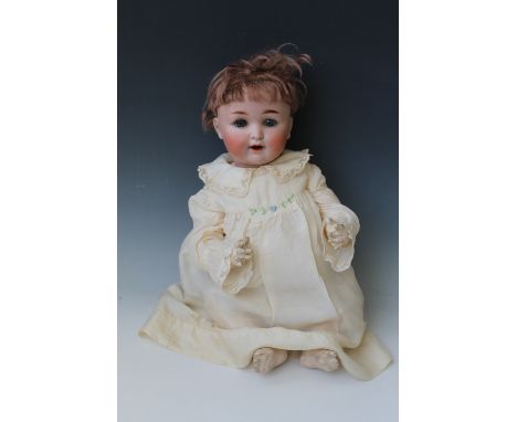 A GERMAN BISQUE HEADED DOLL, with weighted blue sleeping eyes, open mouth with two teeth, jointed composition body with artic