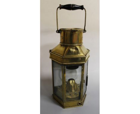 A BRASS SHIP'S LAMP, with canted sides and swing handle, marked 'Eli Griffiths & Sons 1915', H 40 cm Buyers - for shipping pr