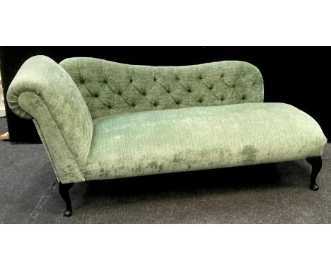 A modern chaise long, scrolling arm, button upholstered back. 80cm high x 176cm long x 64cm deep. 