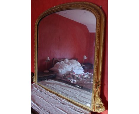A late 19th century arched rectangular gilt over mantel mirror, 114cm high, 131cm wide, c.1860