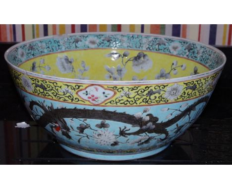 A large early 20th century Chinese Punch bowl, the exterior with scrolling dragon a turquoise ground, the interior with bloss