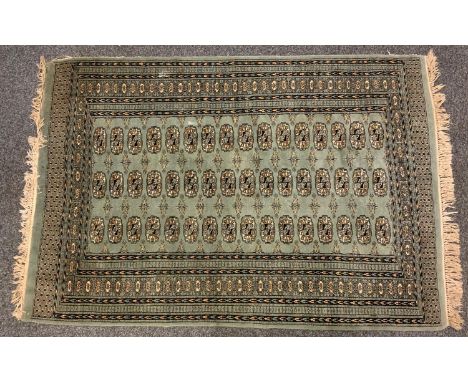 A Persian rug, central panel of three rows of medallions within multi layer border, light blue ground, approx 199cm x 127cm 