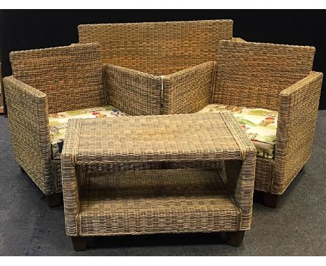 A wicker conservatory suite comprising two seat sofa, two armchairs and a coffee table with under tier. 