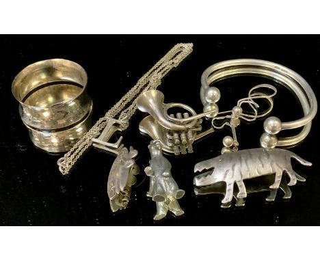 A silver napkin ring; a silver bangle; a silver L pendant; silver charms; etc