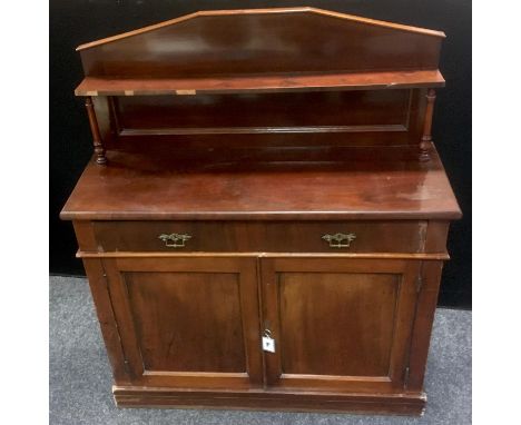 A Victorian mahogany chiffonier, shelf and turned supports to top, long drawer over two door cupboard, plinth base. 130cm hig