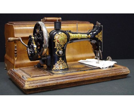 A Vintage Jones CS hand operated portable sewing Machine, I curved walnut case, c.1910 