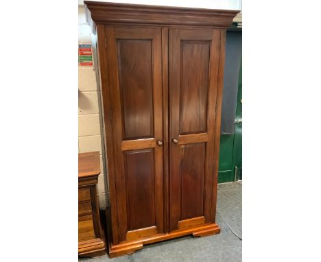 A contemporary mahogany two door wardrobe, fielded panel doors, 196.5cm high, 111.5cm wide, 64.5cm deep 