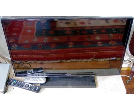 A Hitachi flat screen television and remote control, 32in 