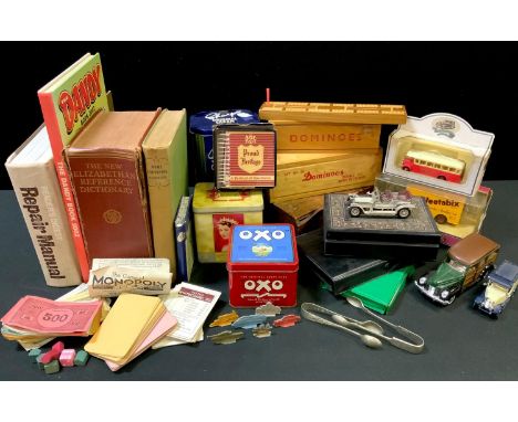 A set of red dominoes, wooden box with sliding cover; other dominoes; cribbage boards; a Monopoloy set, no box or board; mode