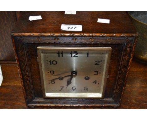 An Art Deco square-shaped oak mantel clock, the 12cm square dial with Arabic numerals, the eight day movement striking on a g