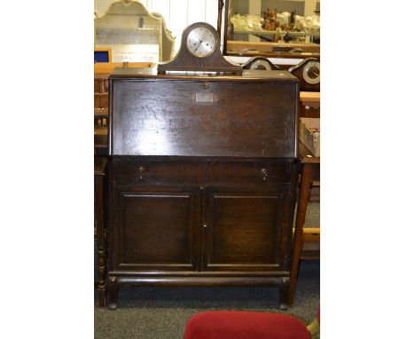 A 1930's Globe Wernicke bureau, the drop down front inscribed with presentation plaque over drawer and doors