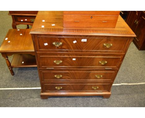 A 20th century TV cabinet as a chest of four long graduated cockbeaded drawers, brass drop handles, bracket feet